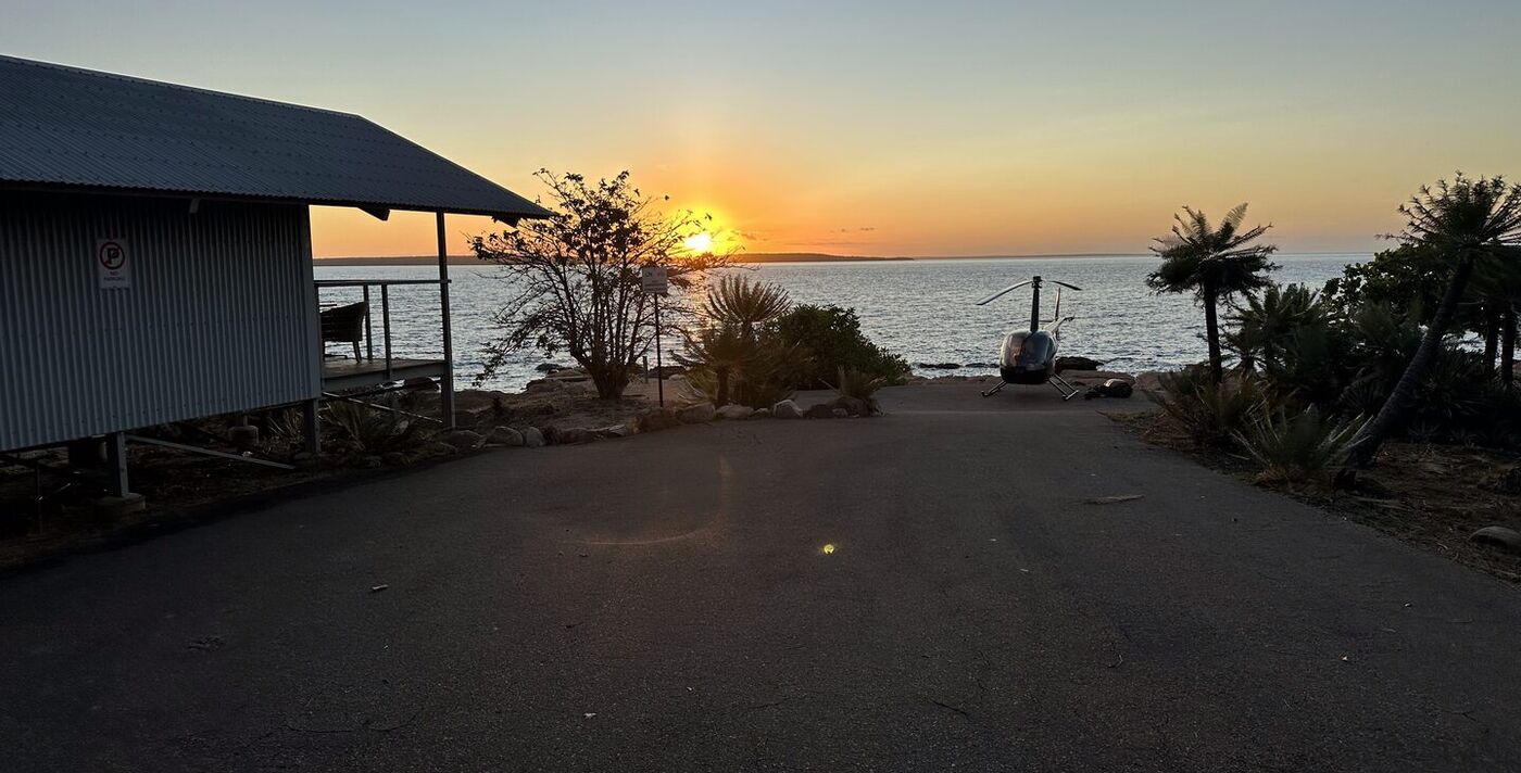 BA Aviation helicopter at the coast at sunset, Cape York